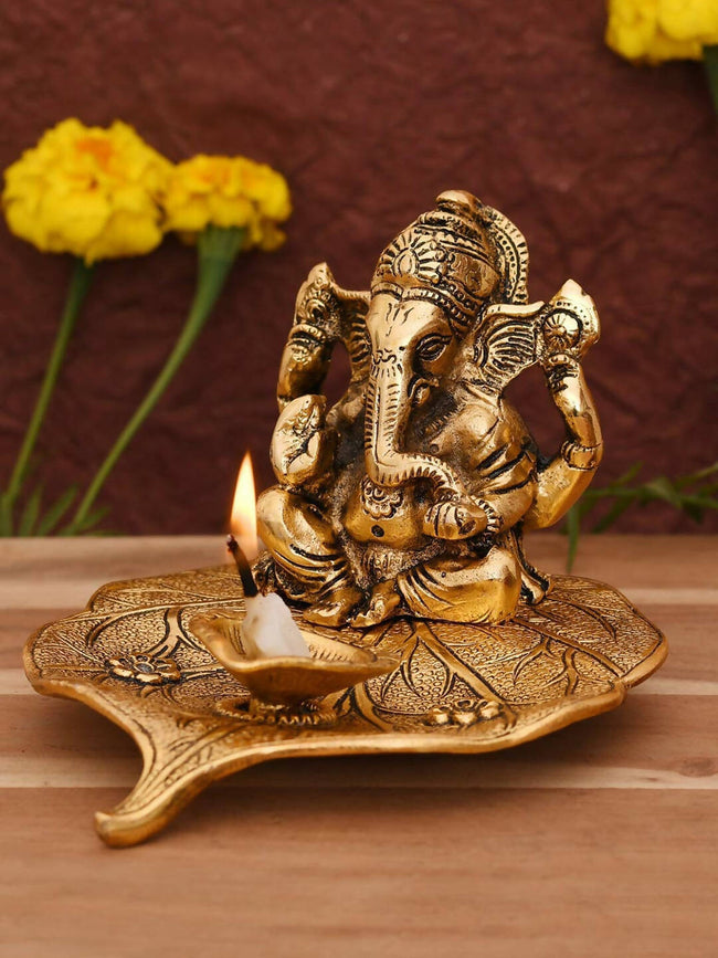 CraftVatika Gold Toned Aluminium Ganesh with Diya Idol Hover Image