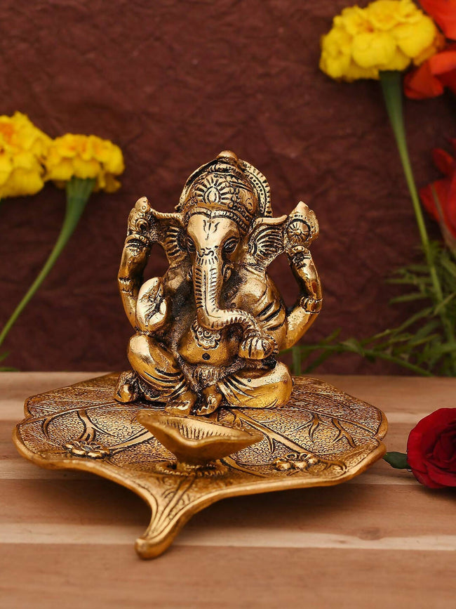 CraftVatika Gold Toned Aluminium Ganesh with Diya Idol Main Image